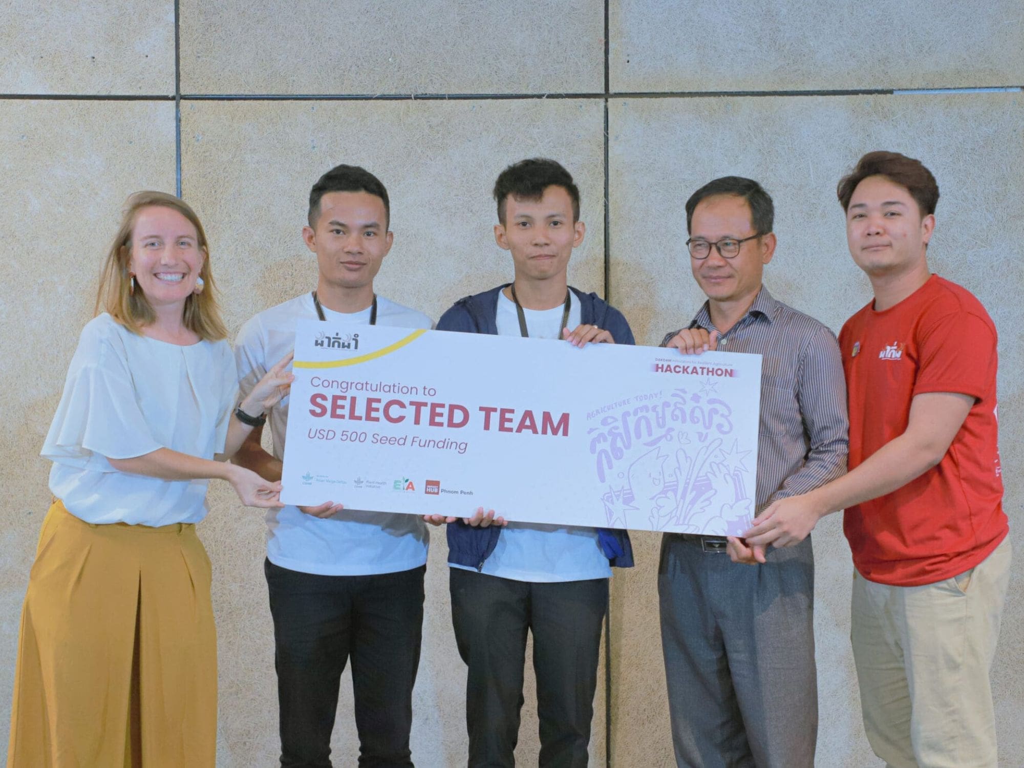 Members of the team Zero Carbon pose with their mentors at the end of the DakDam hackathon.