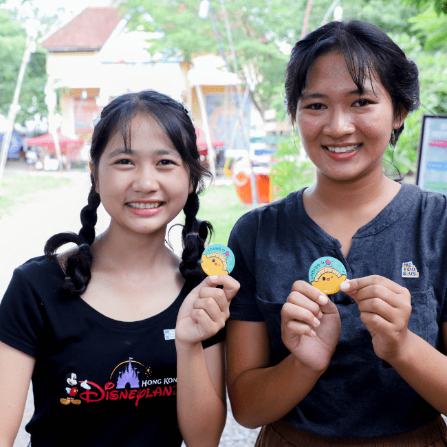 Young females youth holding Kon chet's pin from Berk Chet Festival at BTB