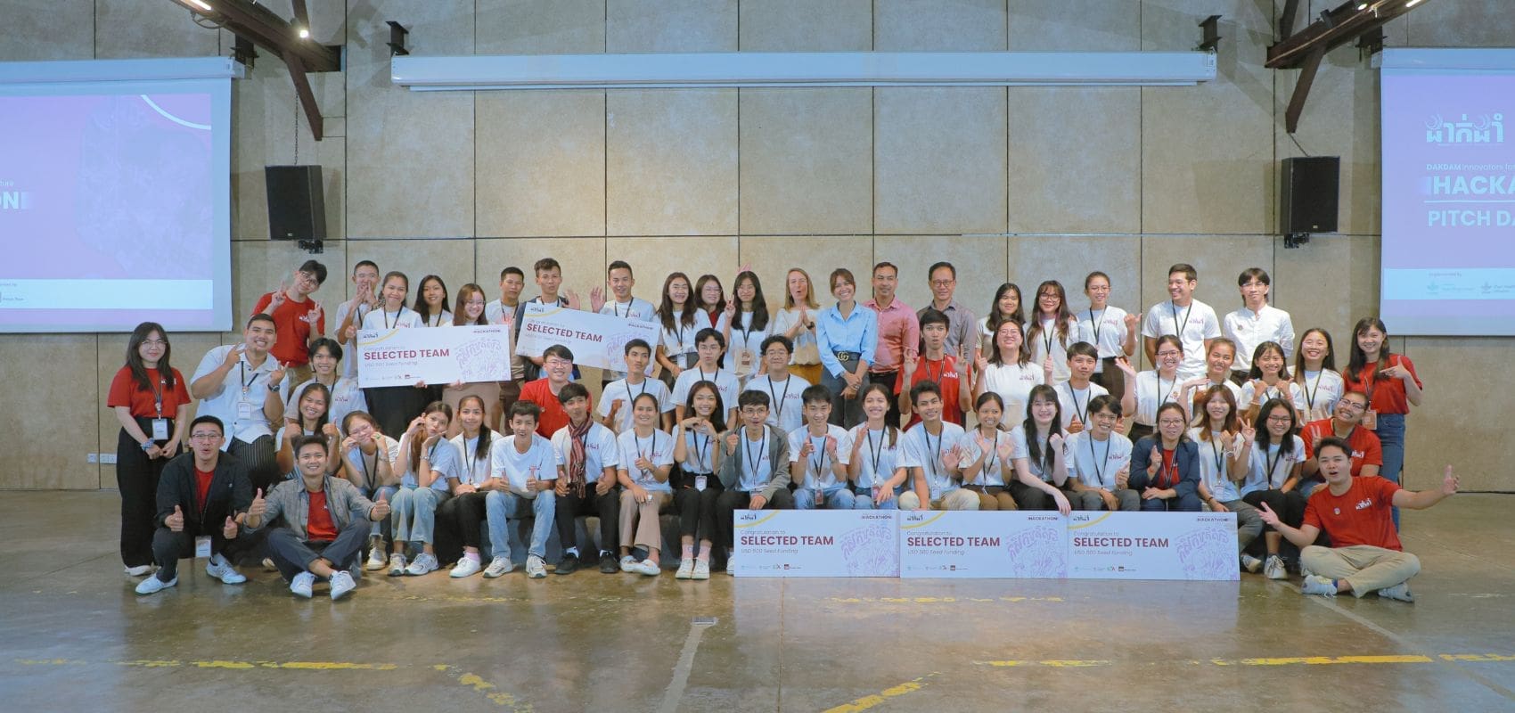 A group of around 50 young Cambodian people pose for a group photo at the end of the DakDam Resilient Agriculture Hackathon organized by Impact Hub Phnom Penh.