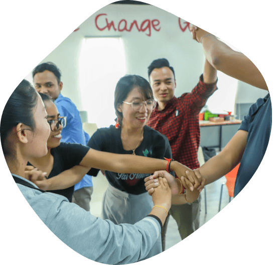 Six young Cambodians, participants in the Changemakers Scale Up program, do a human knot activity together.