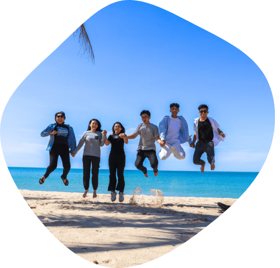 5 participants of the Ending Plastic Pollution Innovation Challenge jump on a beach in Sihanoukville, Cambodia