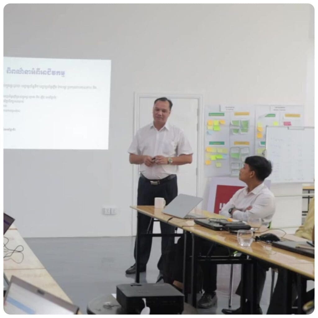 A man speaks to a room of people in Impact Hub Phnom Penh's event space.