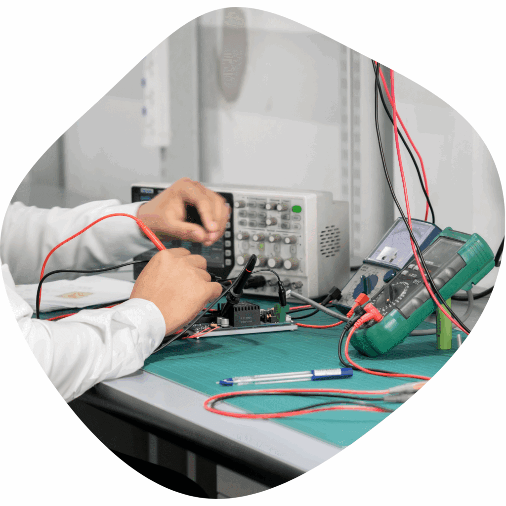 Image of two hands working on some sensors at a table.